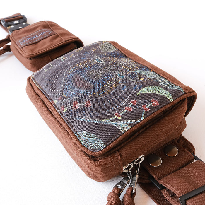 Psychedelic belt bag with UV reactive artwork worn crossbody by Symbolika