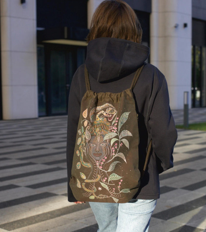Aya Drawstring Bag - Mother Ayahuasca face with leaf patterns on khaki canvas by Symbolika