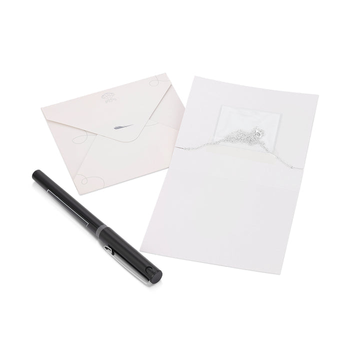 A pen, an envelope, and a card with a chain inside a plastic pouch are arranged on a white surface.