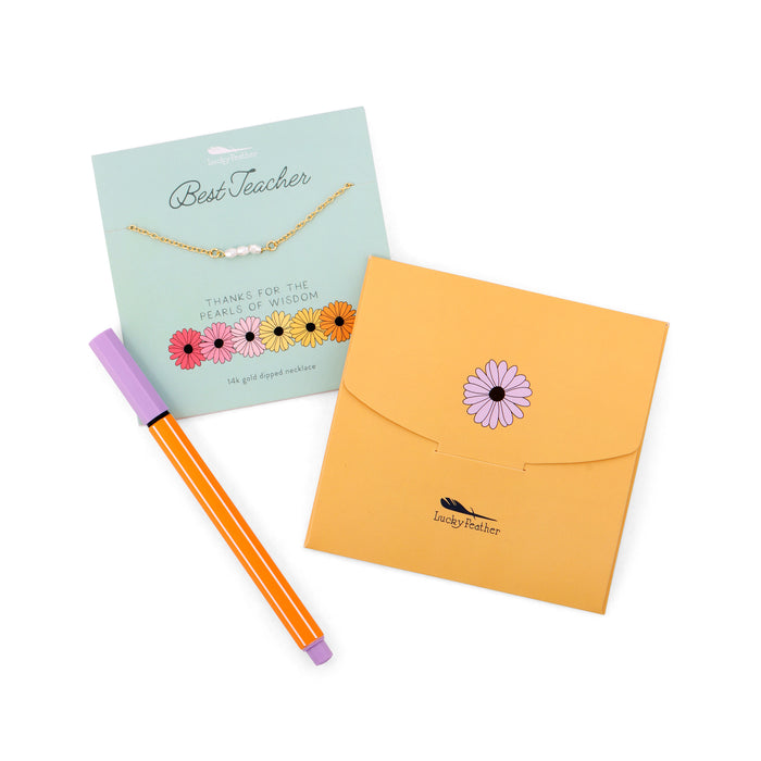 A 'Best Teacher' necklace gift card and envelope lay beside a striped pen.