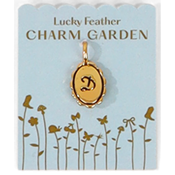 A gold letter 'D' pendant on a 'Lucky Feather Charm Garden' card.