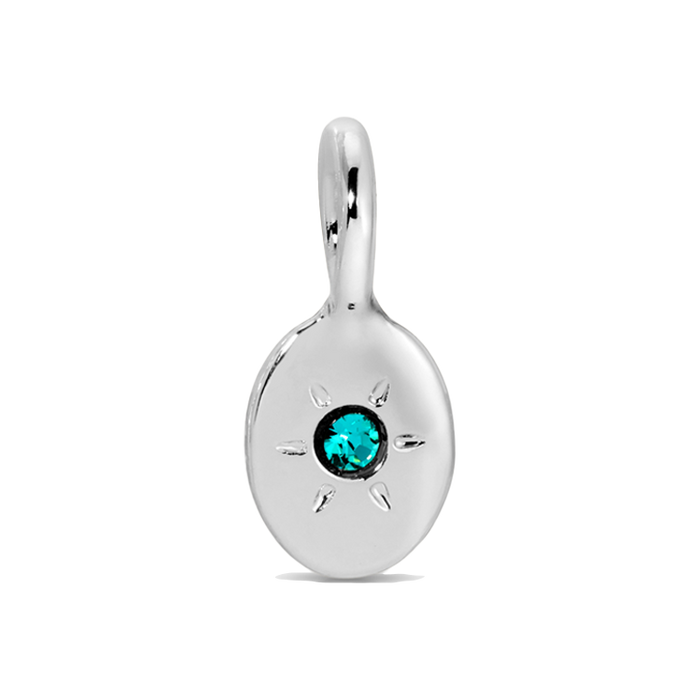 A shiny silver pendant with a teal gemstone.