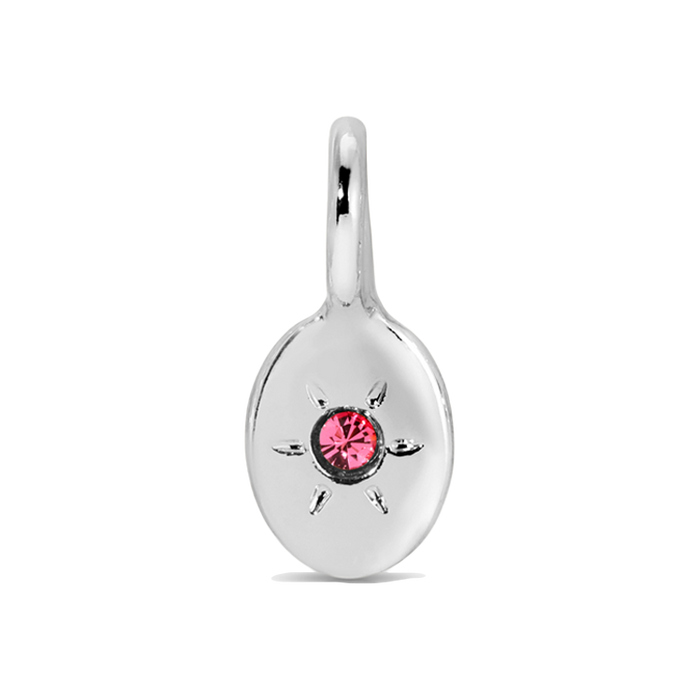 A silver charm with a pink gemstone.