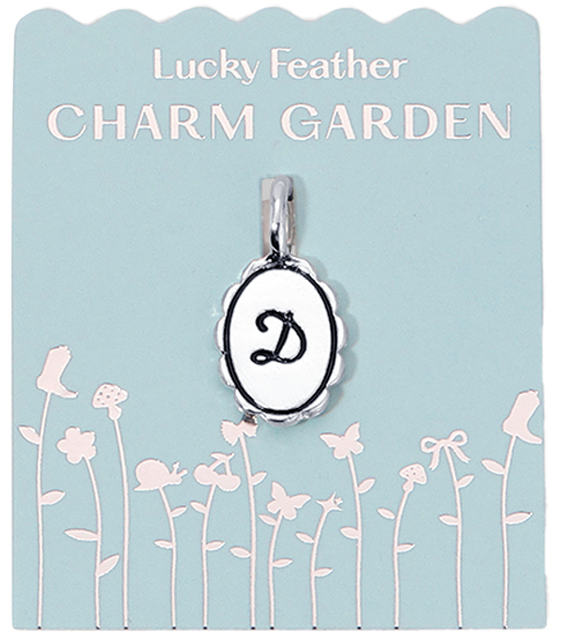 The 'Lucky Feather Charm Garden' package features a charm with the letter 'D' against a light blue background decorated with illustrations of flowers and butterflies.