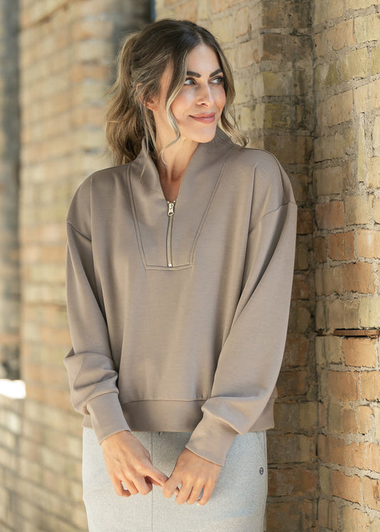 Front view of the cocoa quarter zip sweatshirt highlighting the notched collar and zip placket.