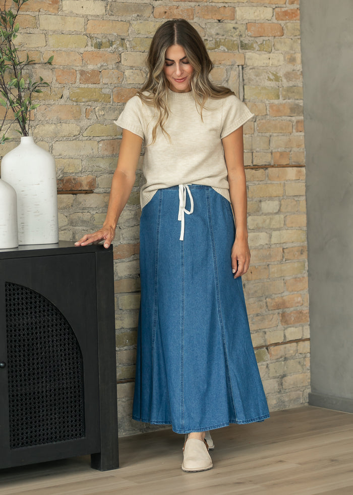 elan Sam Stone crewneck sweater styled with a paneled blue denim maxi skirt.