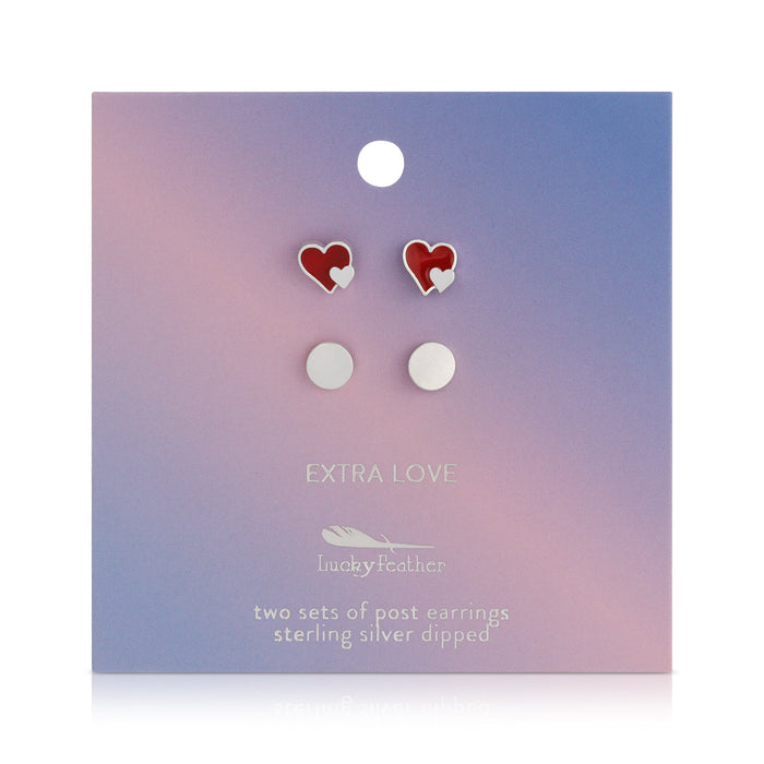 Two sets of post earrings, heart-shaped and round, on a pastel-colored card.