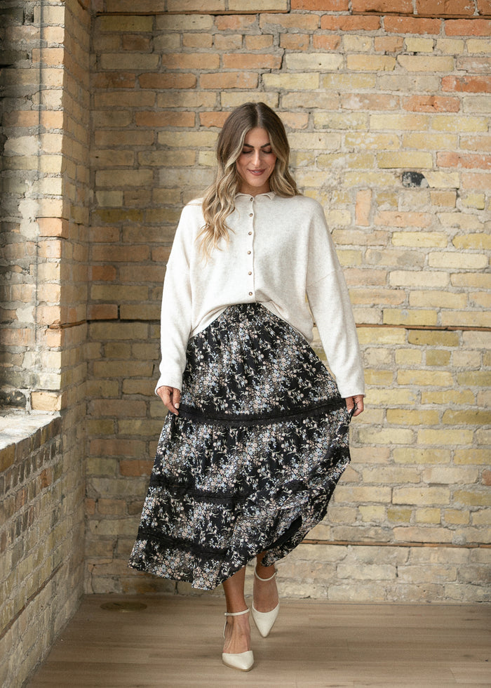 Heather beige button front cardigan styled with a floral midi skirt and heels.
