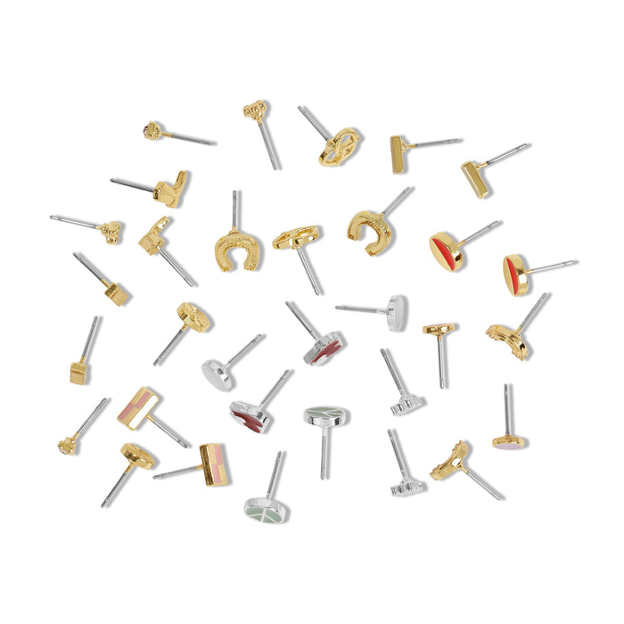 Assorted stud earrings are scattered on a white surface.
