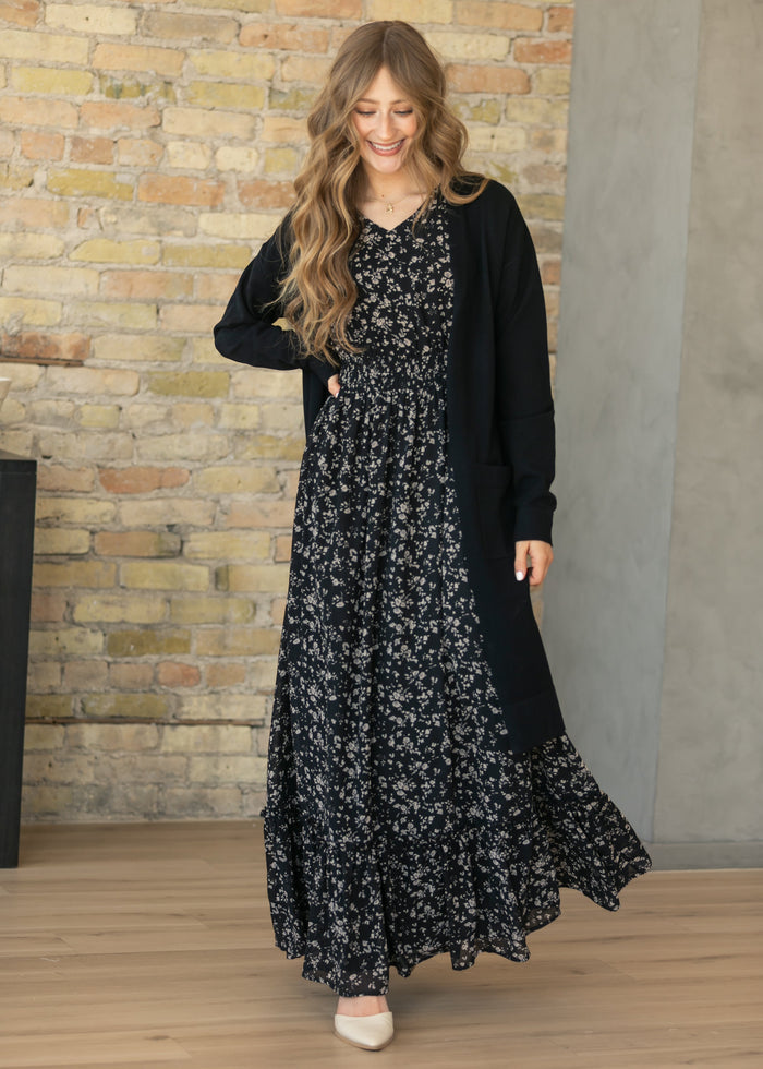 Isabella Black Floral Flutter Sleeve Maxi Dress styled with a black open front cardigan for a modest layered look.