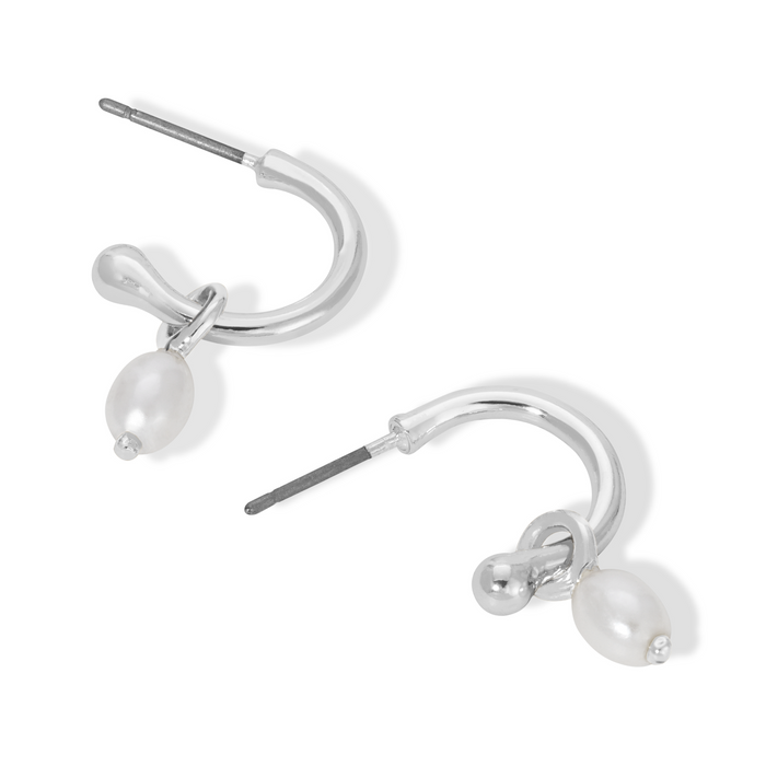 Two silver hoop earrings with a knot detail and a dangling pearl on a white background.