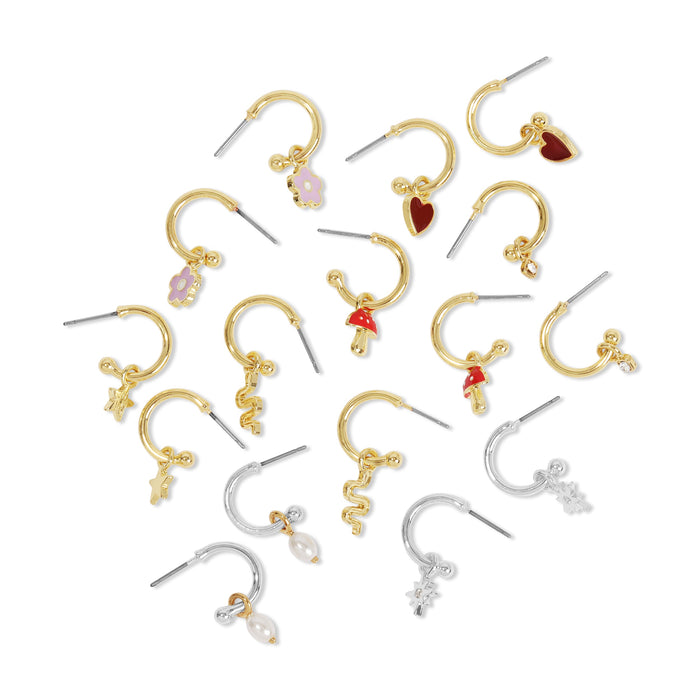 An array of small hoop earrings in gold and silver with different charms.