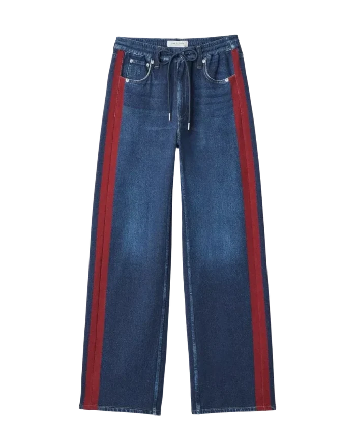 Wrabyn Miramar wide-leg cotton terry track pants in denim-print blue with red side stripes and drawstring waist.