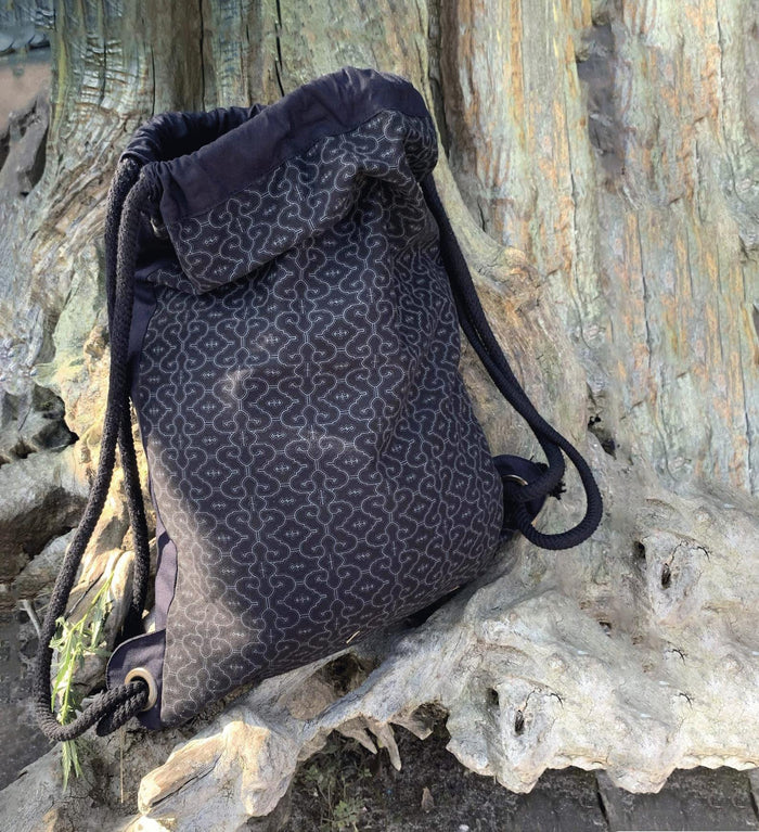 Shipibo Drawstring Bag - White geometric kené patterns on black canvas by Symbolika