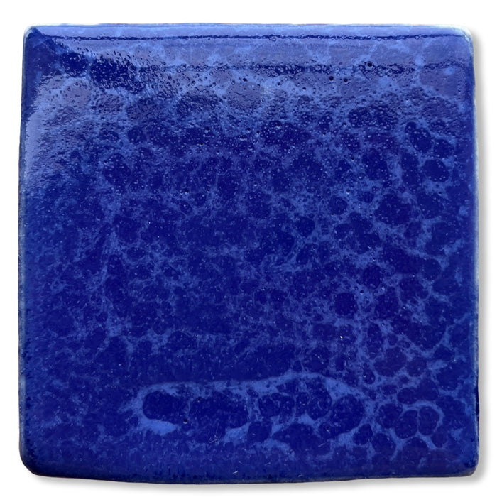 Test tile in SP25 Dark Blue Mottled glaze, deep cobalt blue with a lighter blue mottled surface