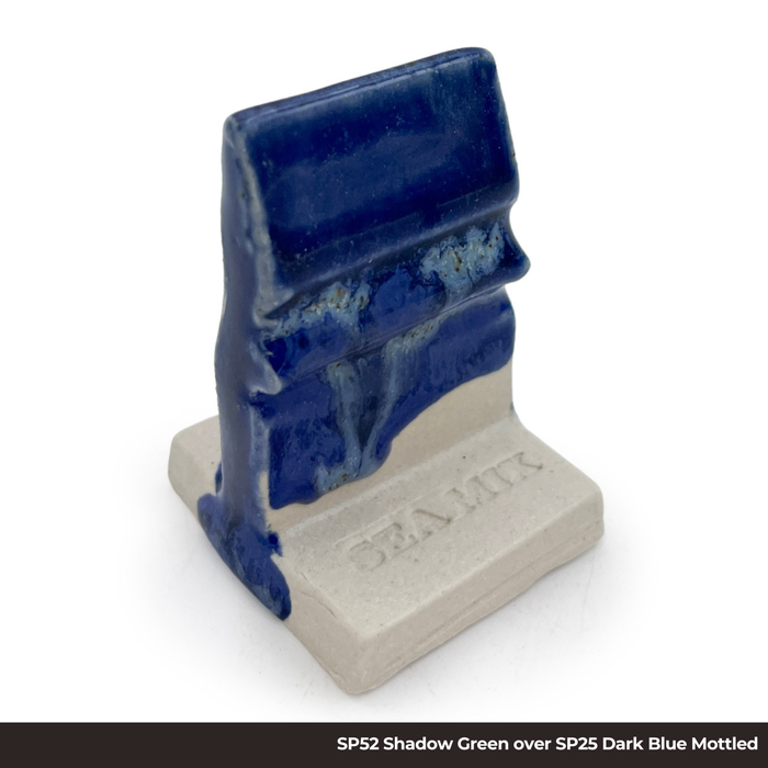 Test tile with SP52 Shadow Green glaze over SP25 Dark Blue Mottled glaze, dark blue with pale blue streaks