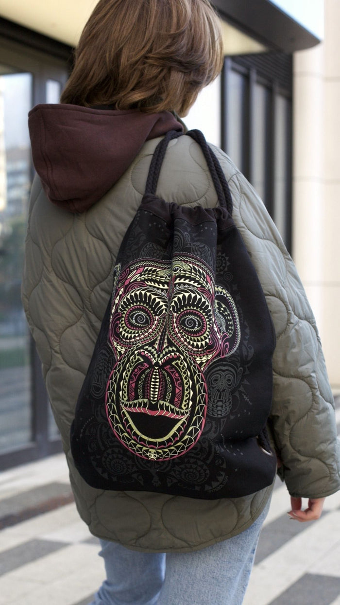Tā Moko Drawstring Bag - Geometric face designs with purple patterns by Symbolika