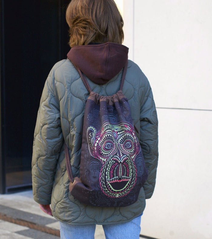Tā Moko Drawstring Bag - Brown tribal face art with geometric patterns by Symbolika