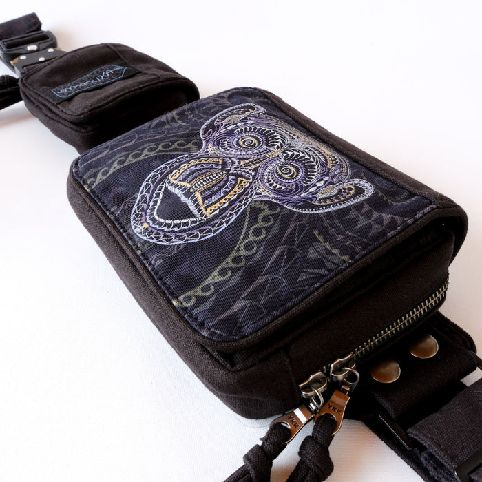 UV reactive belt bag glowing under blacklight - purple and gold primate art design