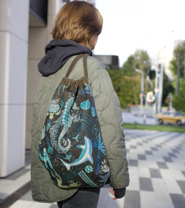 Blueprint 2 SEA drawstring bag - serpentine geometric art on brown canvas by Symbolika